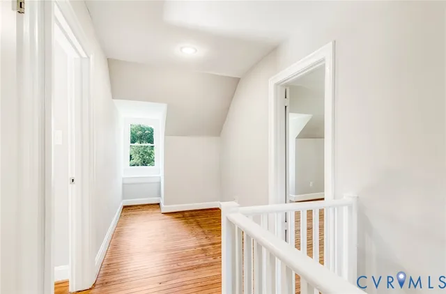 a view of a room with wooden floor and chandelier