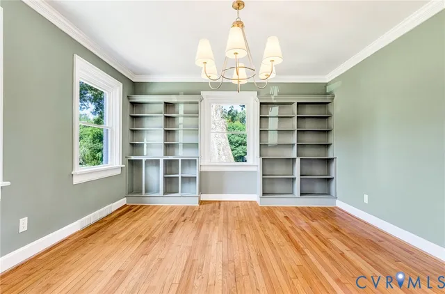 an aerial view of a house with a yard and lake view