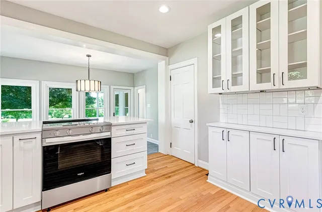 an empty room with wooden floor and a window