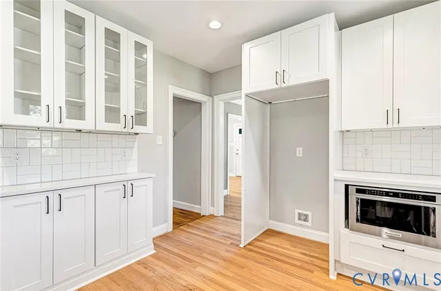 a bathroom with a sink a toilet a mirror and shower