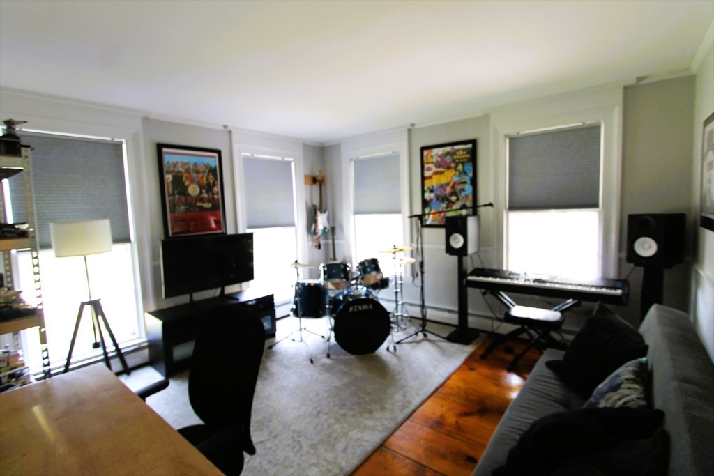 9 Newton Junction Road Kingston, NH 03848 - Photo 17 of 40 a living room with furniture a piano and a flat screen tv