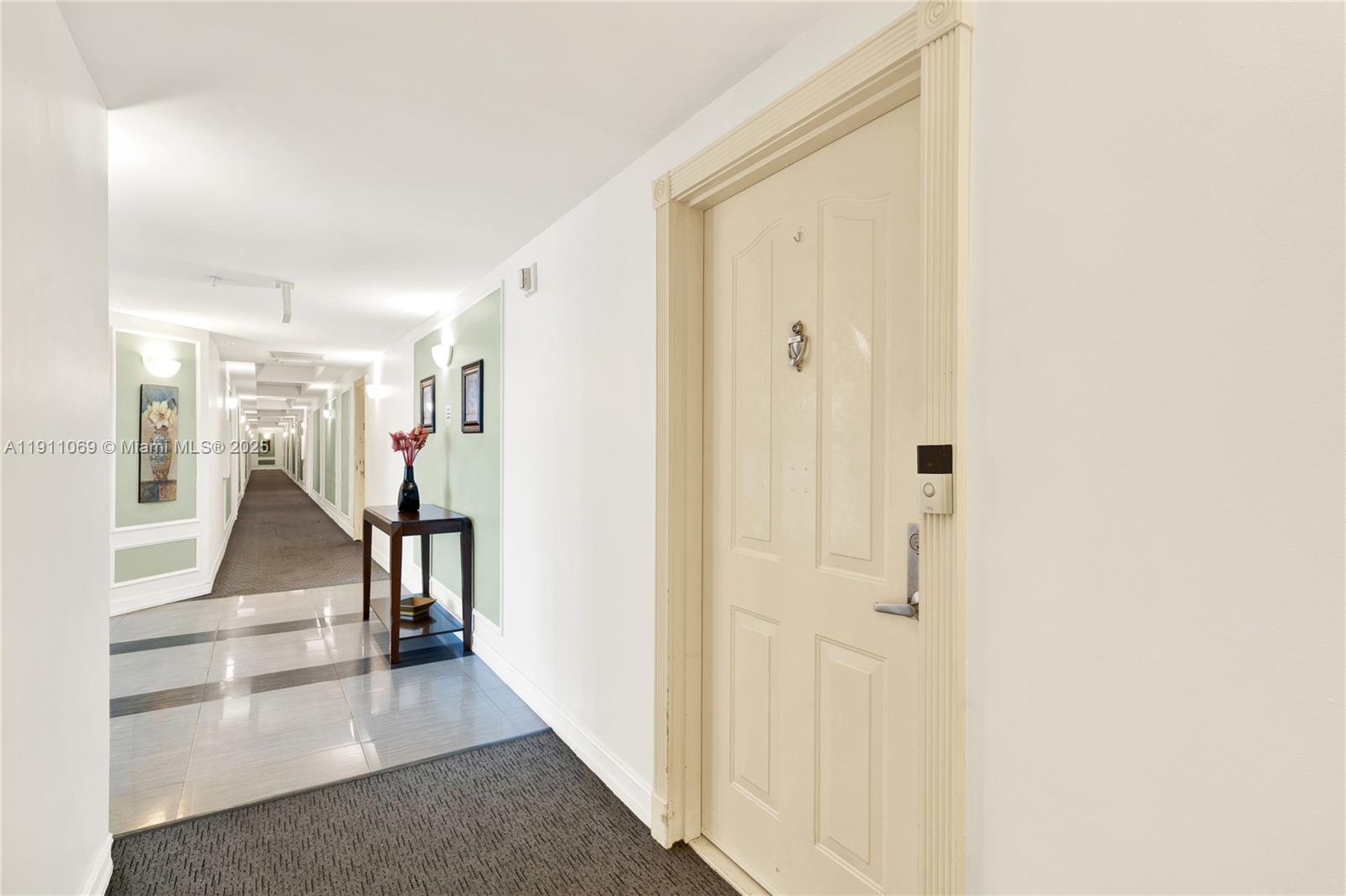 a view of a hallway with wooden floor and entryway