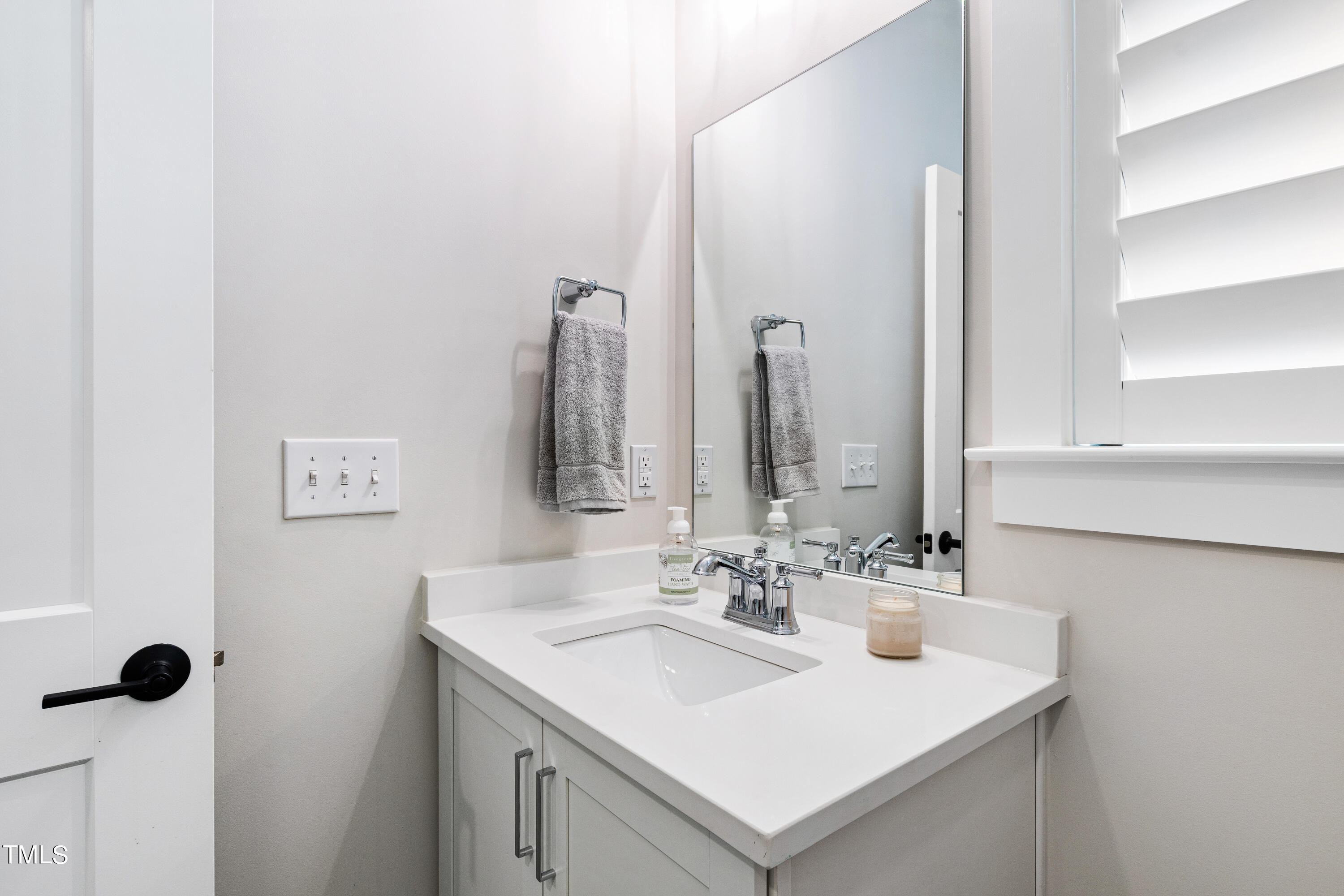 1610 Draper View Loop, Unit 106 Raleigh, NC 27608 - Photo 21 of 36 a bathroom with a sink and a mirror