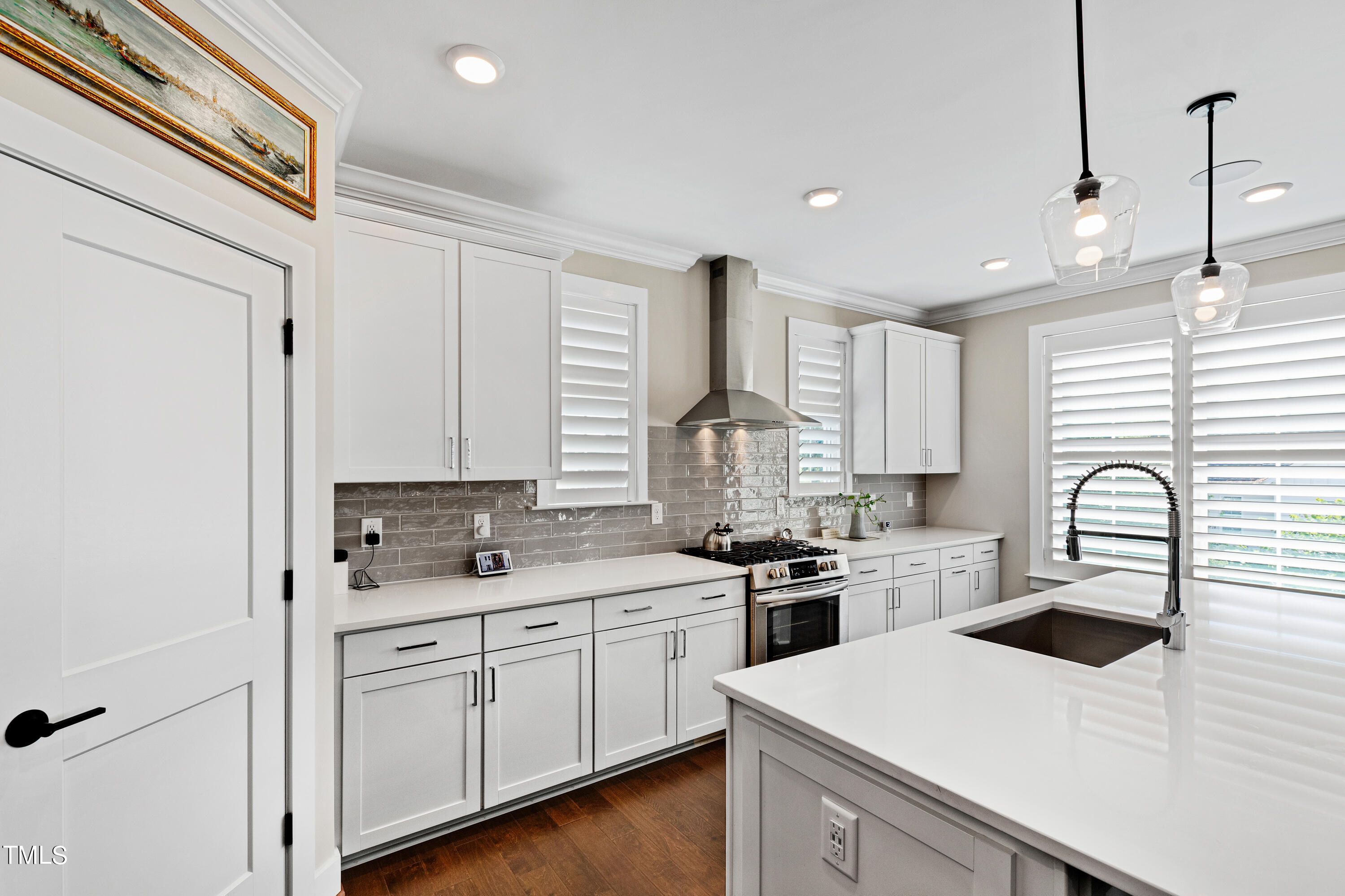 1610 Draper View Loop, Unit 106 Raleigh, NC 27608 - Photo 10 of 36 a kitchen with a sink a stove and cabinets