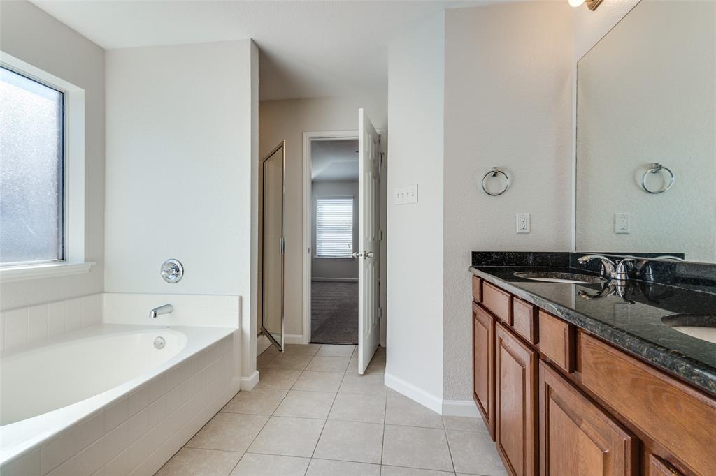 1257 Barrel Run Fort Worth, TX 76052 - Photo 14 of 26 Bathroom featuring a built-in tub, separate glass-enclosed shower, dual vanity with wood cabinetry, and granite countertop