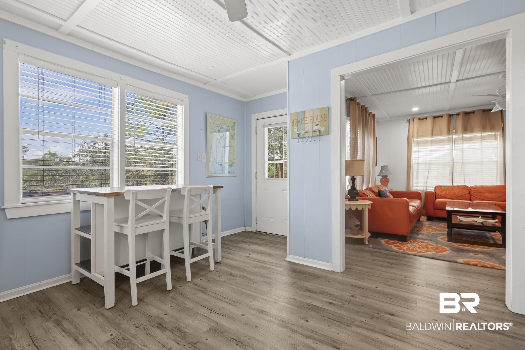 562 Veterans Road Gulf Shores, AL 36542 - Photo 10 of 32 Dining space featuring wood finished floors, plenty of natural light, and baseboards