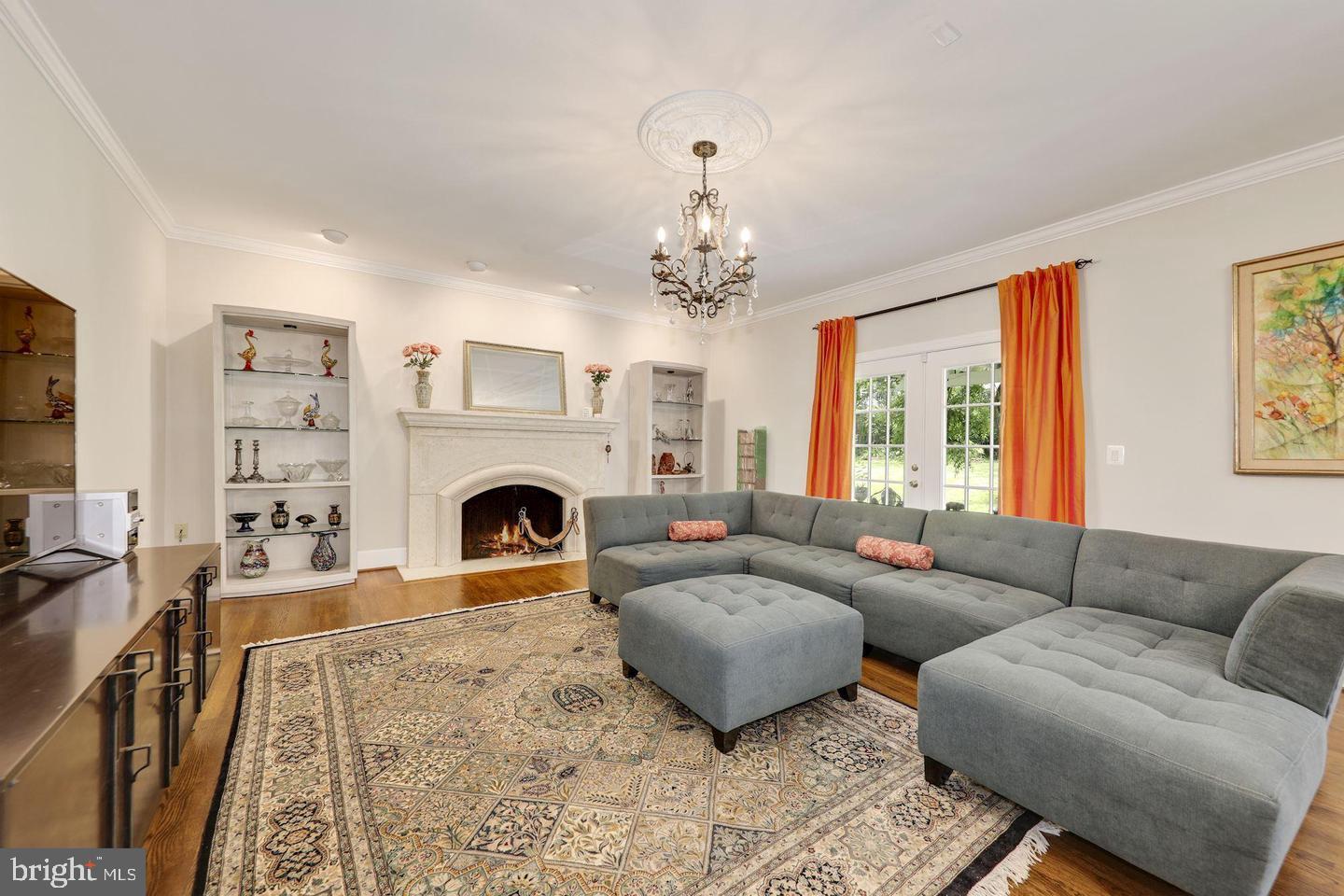 9809 Hall Road Potomac, MD 20854 - Photo 20 of 60 a living room with furniture a large window and a fireplace
