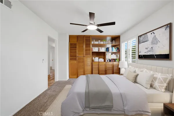 a bedroom with a large bed and a large mirror