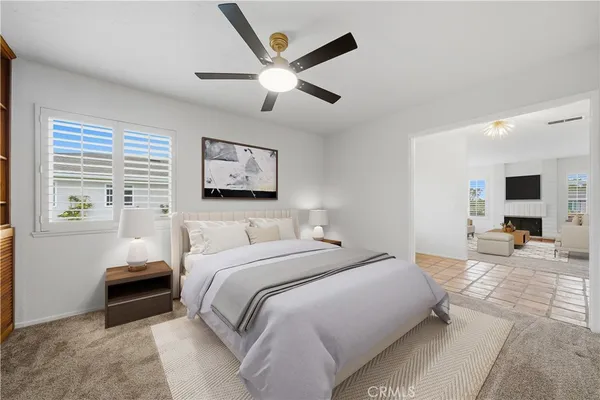 a spacious bedroom with a bed and ceiling fan