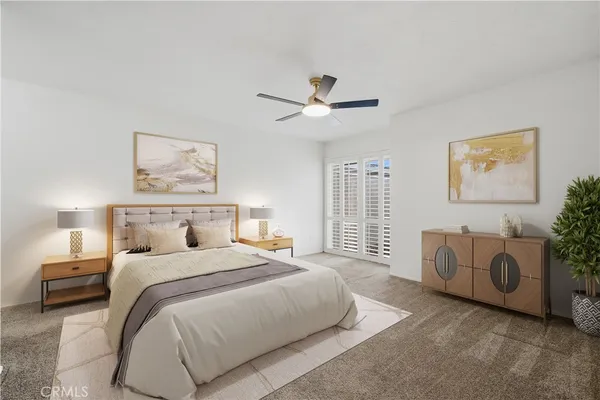 a spacious bedroom with a bed and a couch