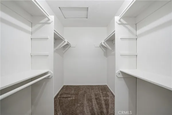 a view of walk in closet with empty racks