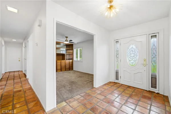 a view of a hallway view with wooden floor and workspace