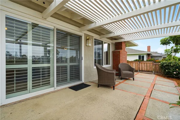 a view of a patio with table and chairs and potted plants