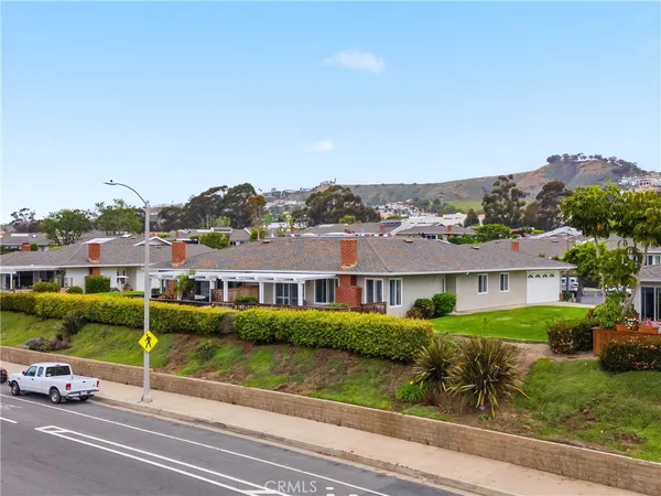 an aerial view of residential houses with outdoor space and river