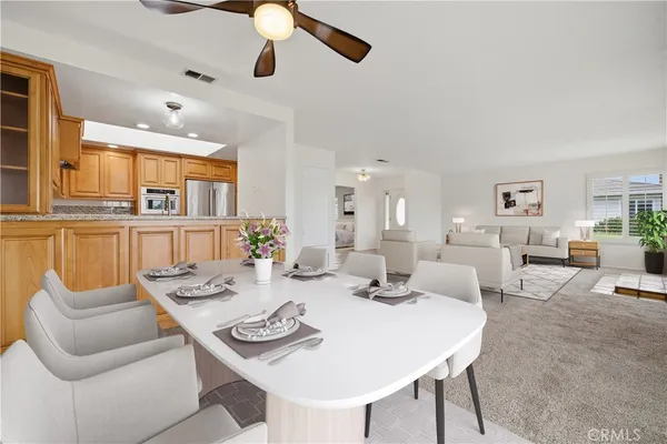 a view of a dining room with furniture and a kitchen