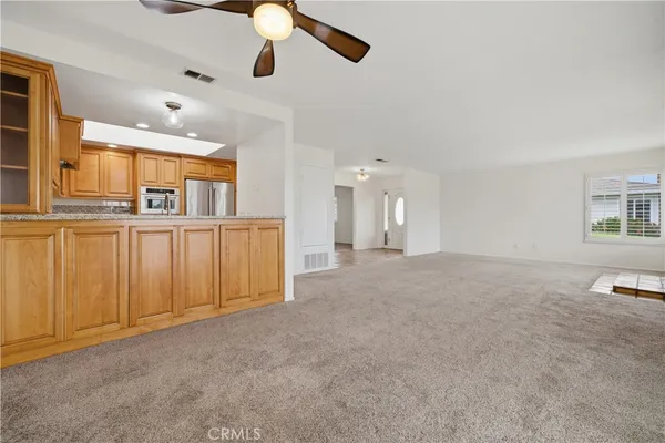 a view of a livingroom with furniture cabinet wooden floor and windows