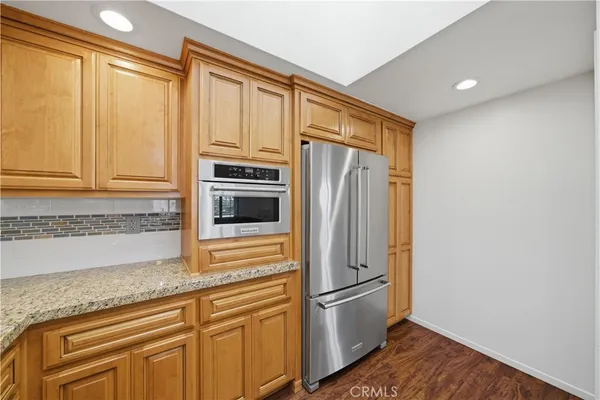a kitchen with stainless steel appliances a refrigerator and cabinets
