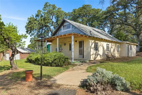 a living room with furniture kitchen view and a flat screen tv
