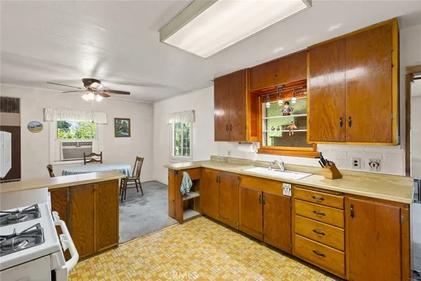 a living room with furniture a fireplace and a floor to ceiling window