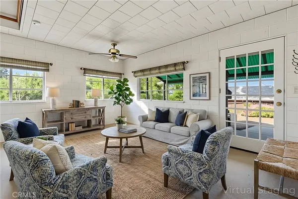 a view of a livingroom with workspace and a window