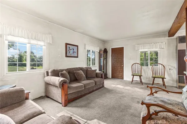 a living room with stainless steel appliances kitchen island granite countertop furniture and a view of kitchen