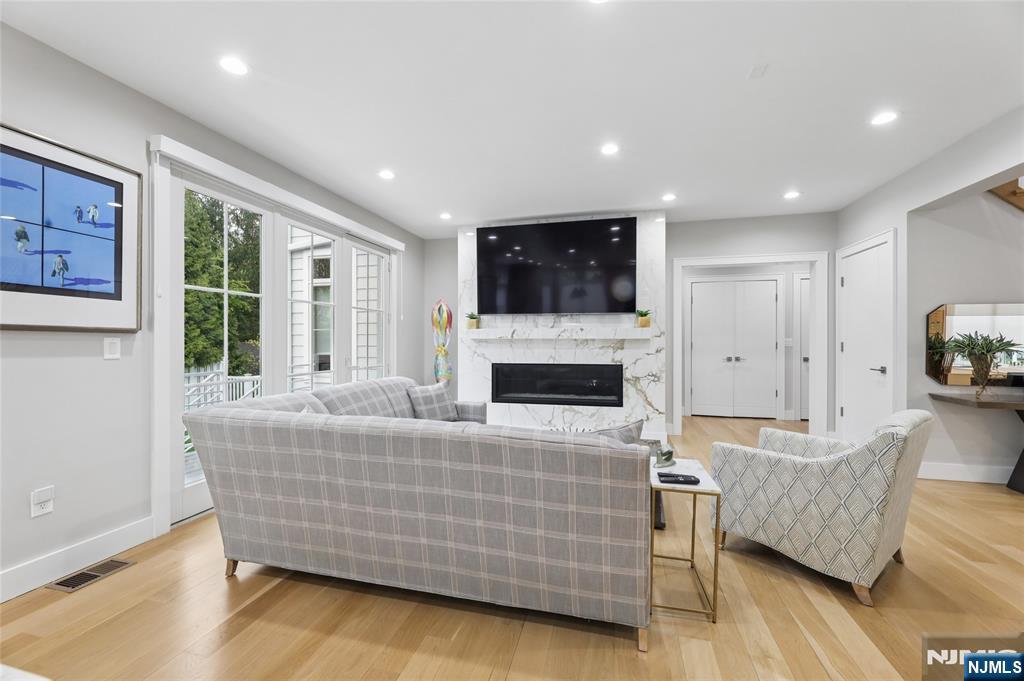 31 Engleside Street Cresskill, NJ 07626 - Photo 10 of 49 a living room with furniture fireplace and flat screen tv