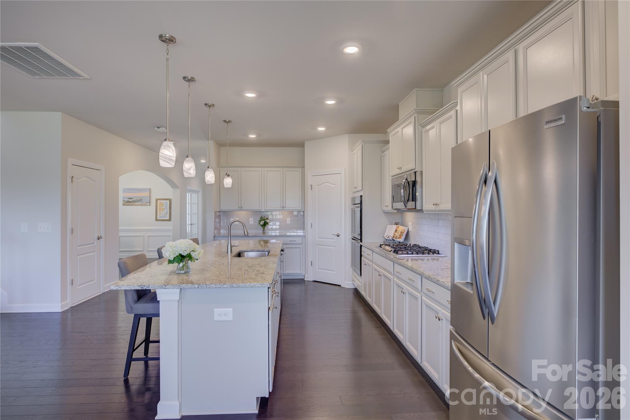 16541 Cozy Cove Road Charlotte, NC 28278 - Photo 11 of 47 a kitchen with kitchen island a counter top space a sink stainless steel appliances and cabinets