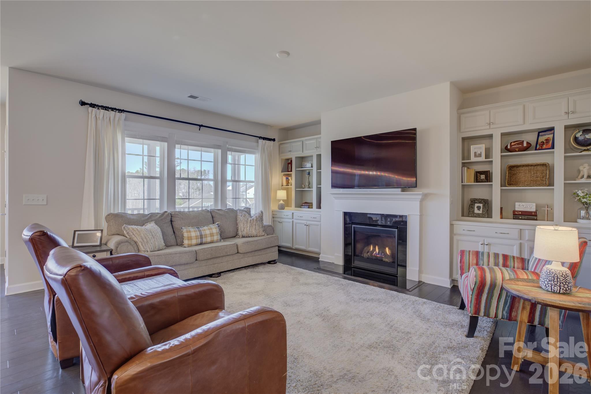 16541 Cozy Cove Road Charlotte, NC 28278 - Photo 18 of 47 a living room with furniture a fireplace and a flat screen tv