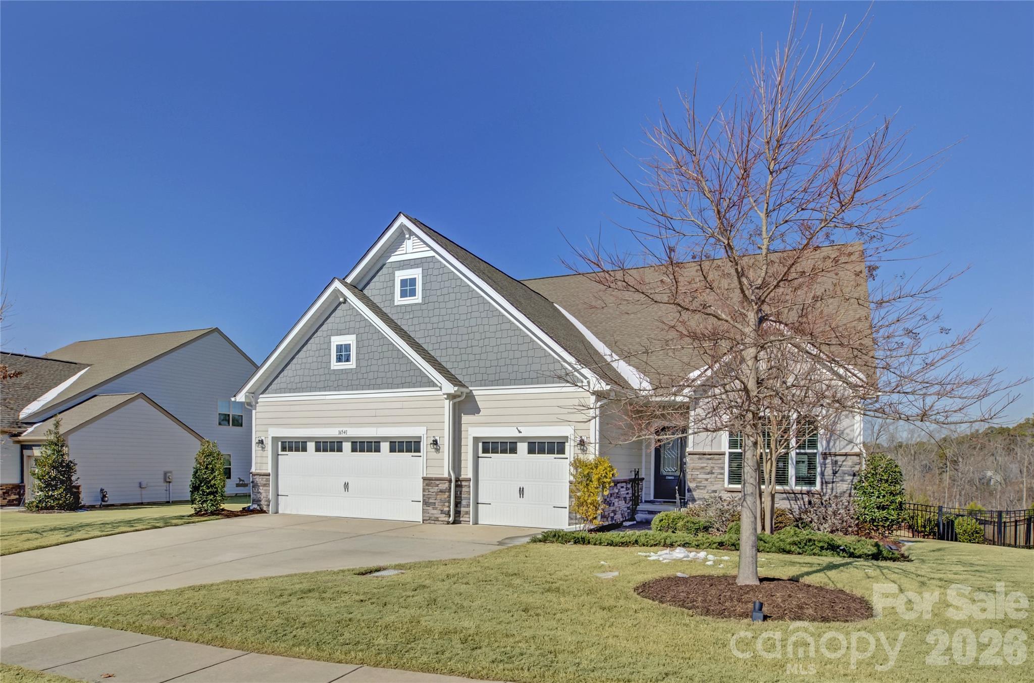16541 Cozy Cove Road Charlotte, NC 28278 - Photo 2 of 47 a front view of a house with a yard and garage