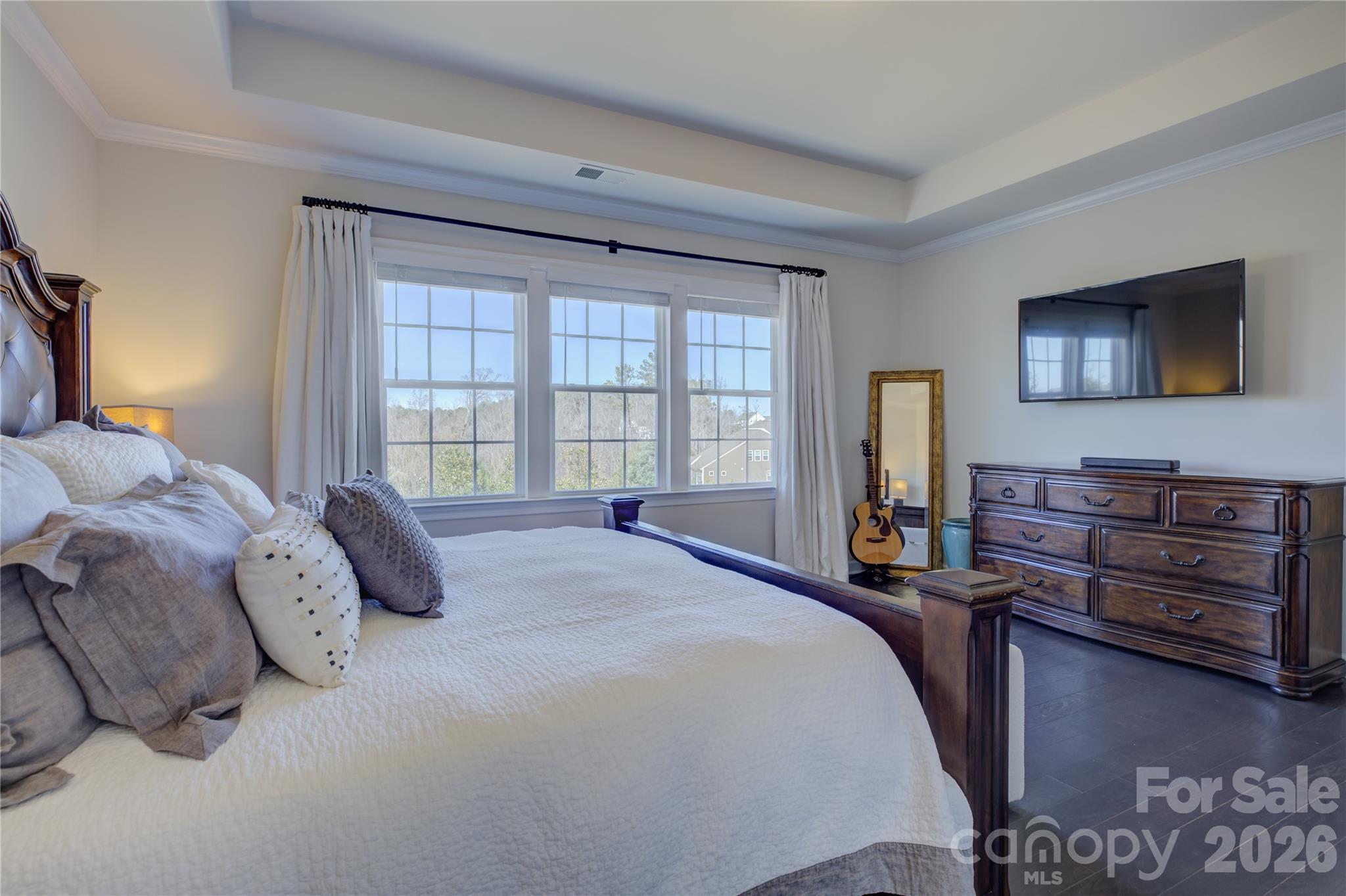 16541 Cozy Cove Road Charlotte, NC 28278 - Photo 21 of 47 a bedroom with a bed and a flat tv screen on dresser