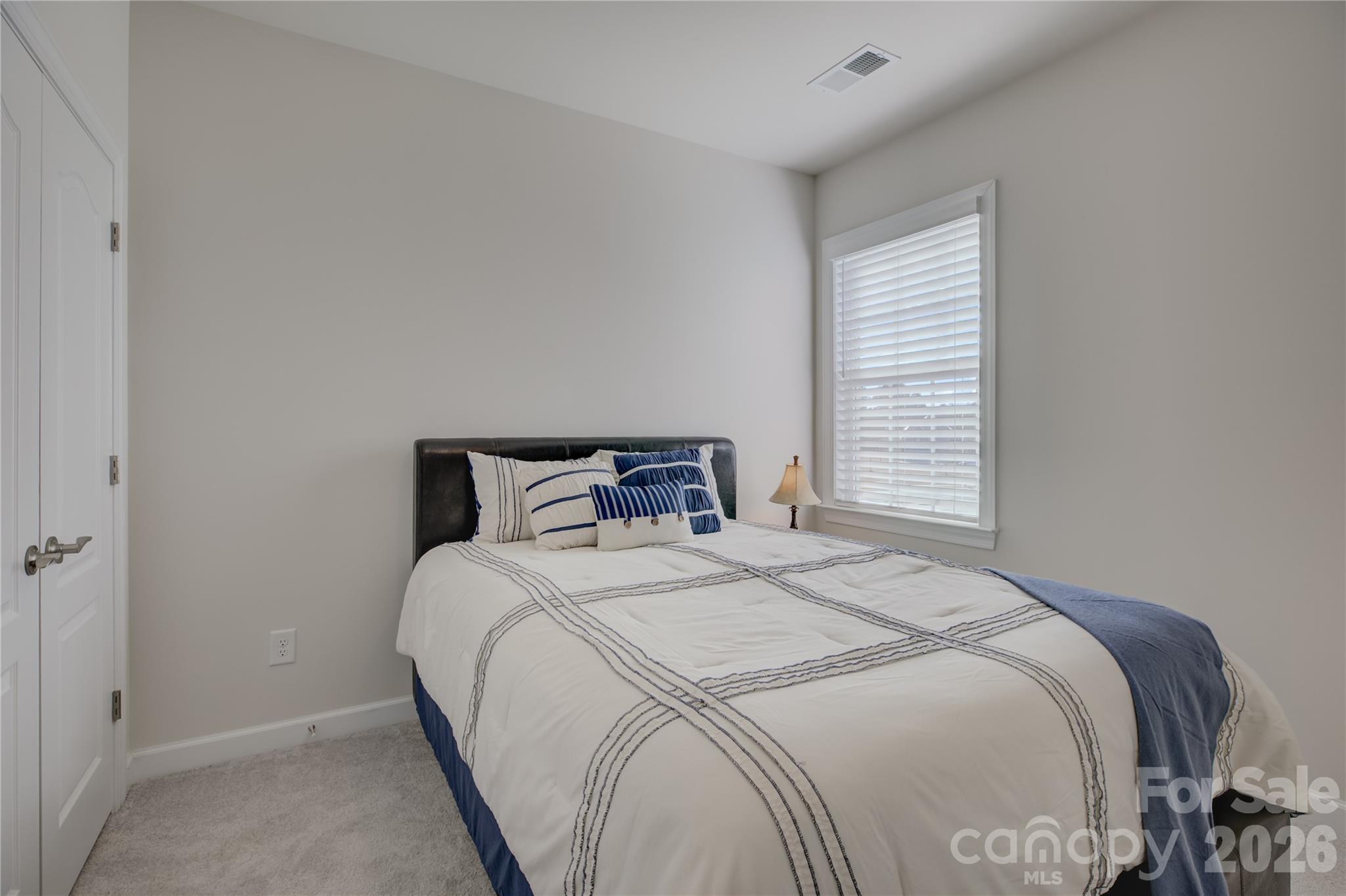 16541 Cozy Cove Road Charlotte, NC 28278 - Photo 31 of 47 a bedroom with a bed and a window