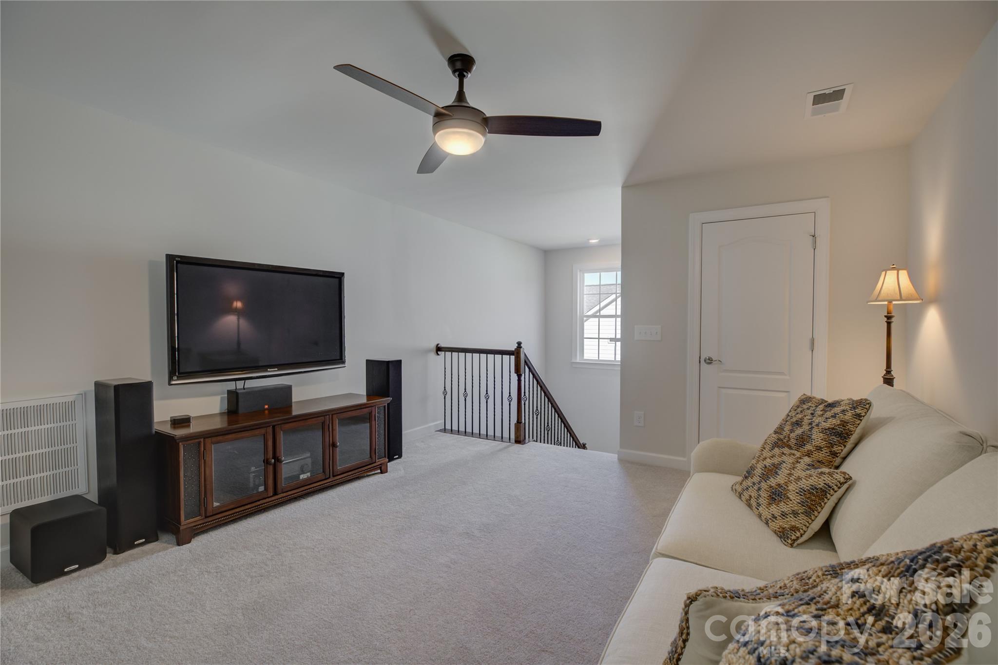 16541 Cozy Cove Road Charlotte, NC 28278 - Photo 32 of 47 a bedroom with furniture and a flat screen tv
