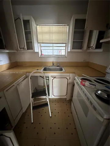 a utility room with sink dryer and washer