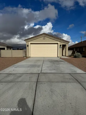 a view of a house with a yard and garage