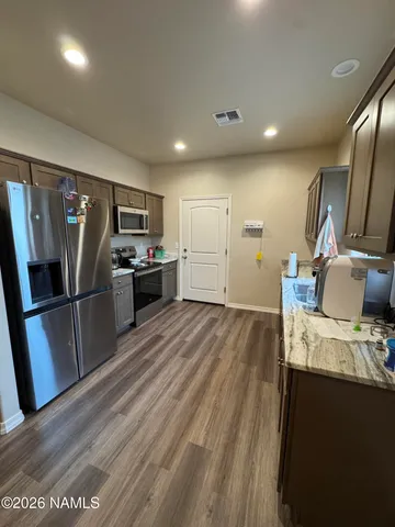 a kitchen with a refrigerator and a sink