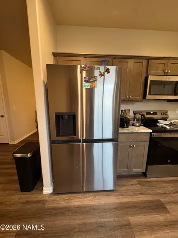 a kitchen with a refrigerator and a stove