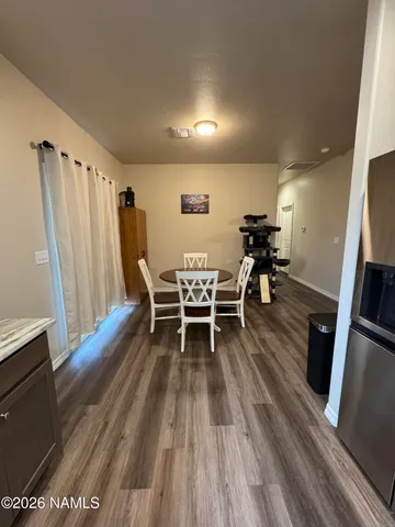 a dining room with furniture and wooden floor
