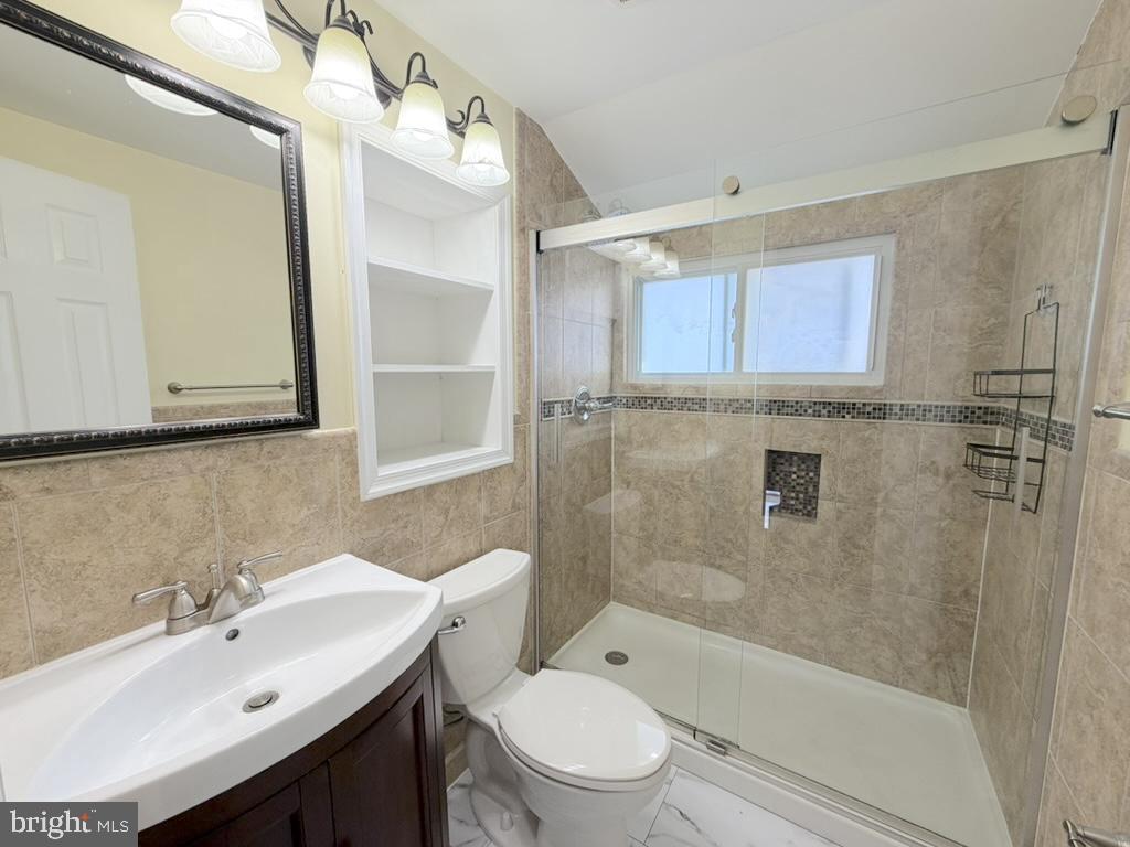 56 Indian Red Road Levittown, PA 19057 - Photo 15 of 19 a bathroom with a sink a toilet and shower