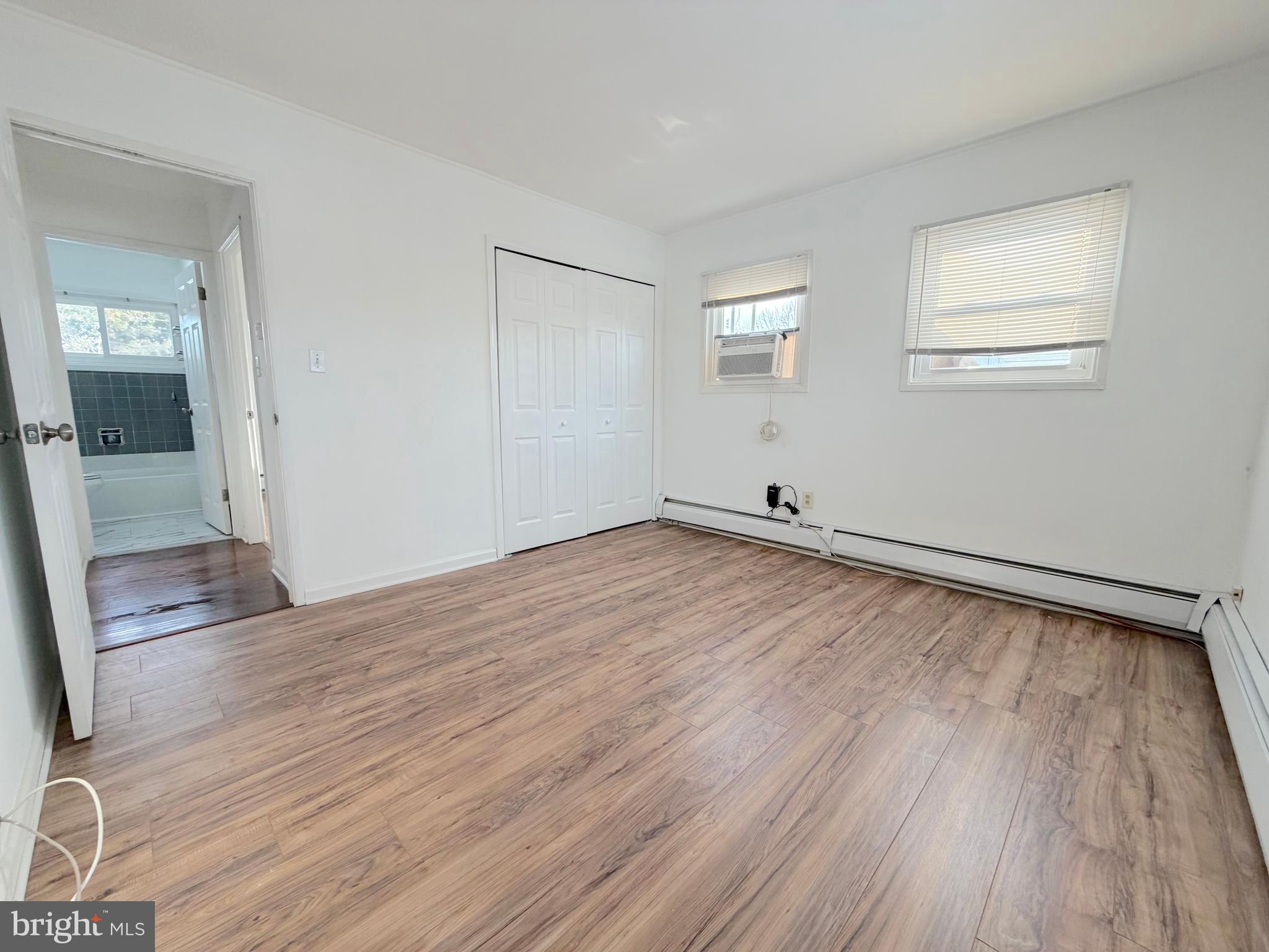 56 Indian Red Road Levittown, PA 19057 - Photo 5 of 19 an empty room with wooden floor and windows
