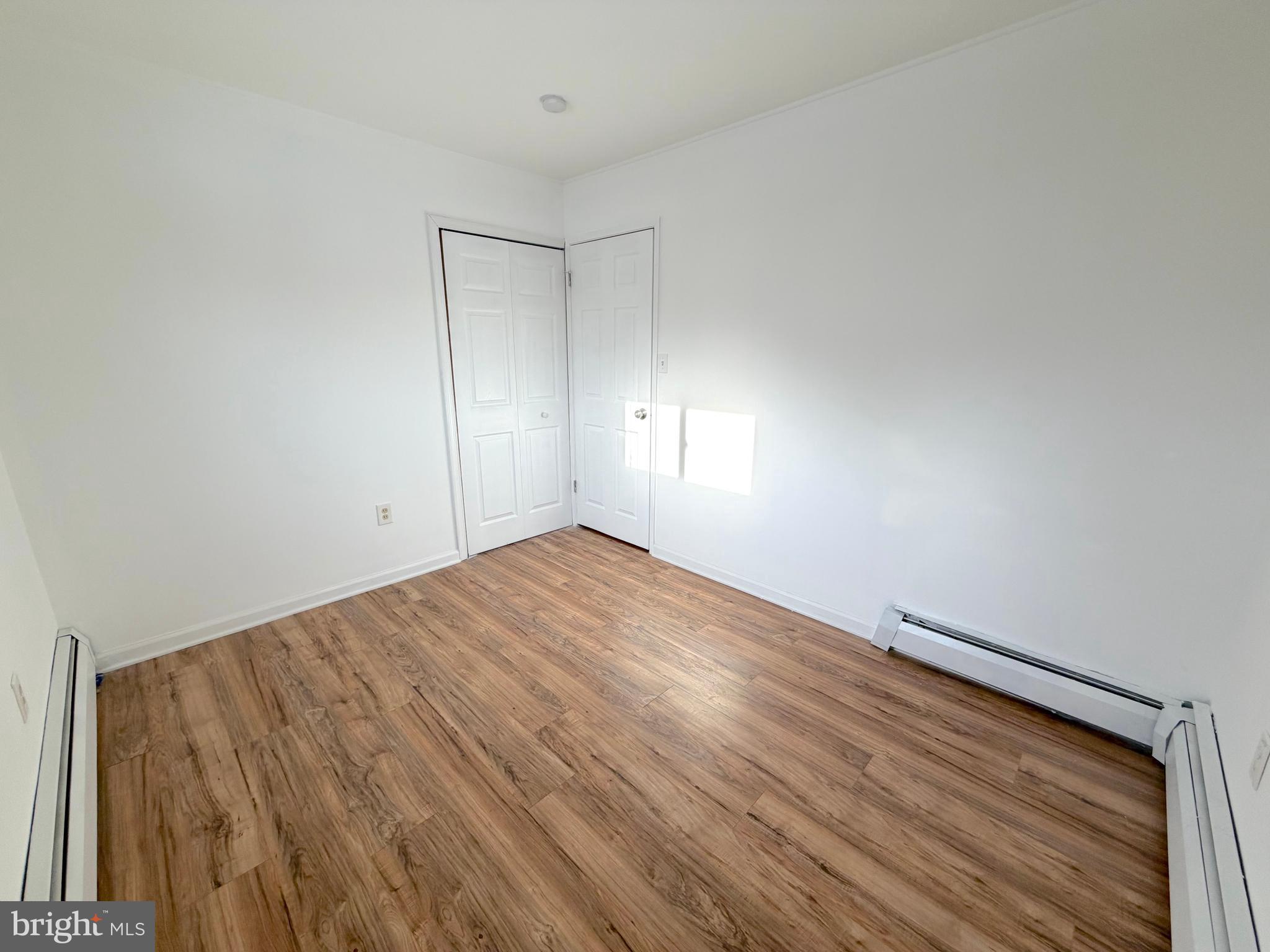 56 Indian Red Road Levittown, PA 19057 - Photo 7 of 19 a view of empty room with wooden floor