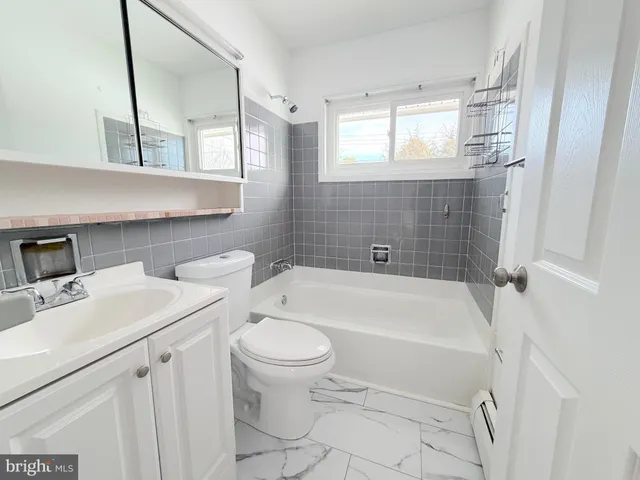 a bathroom with a sink a toilet and bathtub