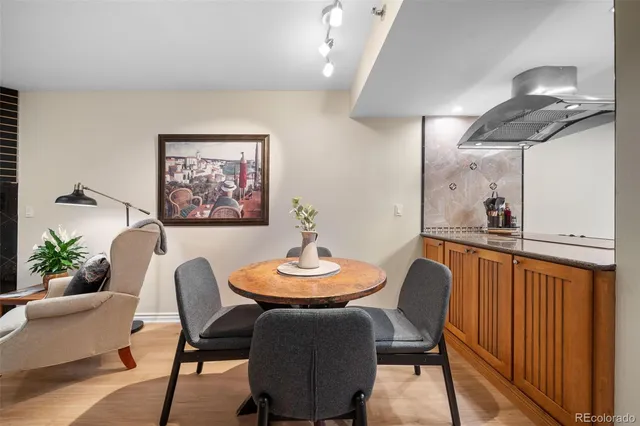 a living room with dining room and wooden floor