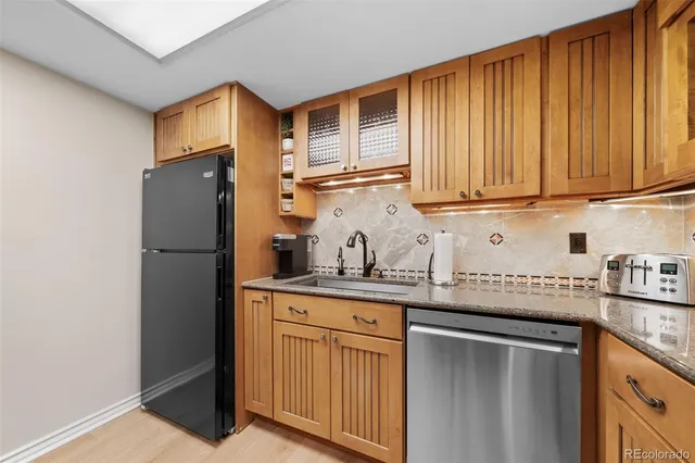 a kitchen with stainless steel appliances granite countertop a sink and cabinets