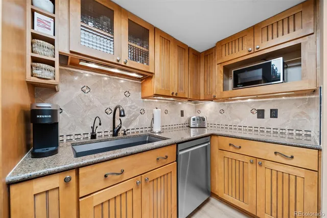 a kitchen with a stove and a wooden floor