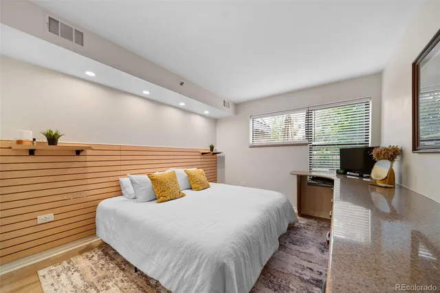 a bedroom with a bed and a dresser