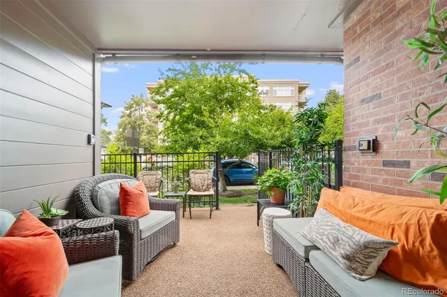 a view of a patio with table and chairs under an umbrella