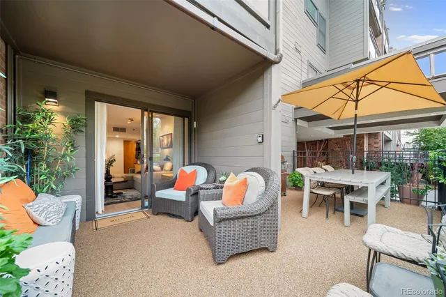 a view of a balcony with wooden floor and outdoor seating