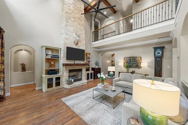 a living room with fireplace furniture and a wooden floor