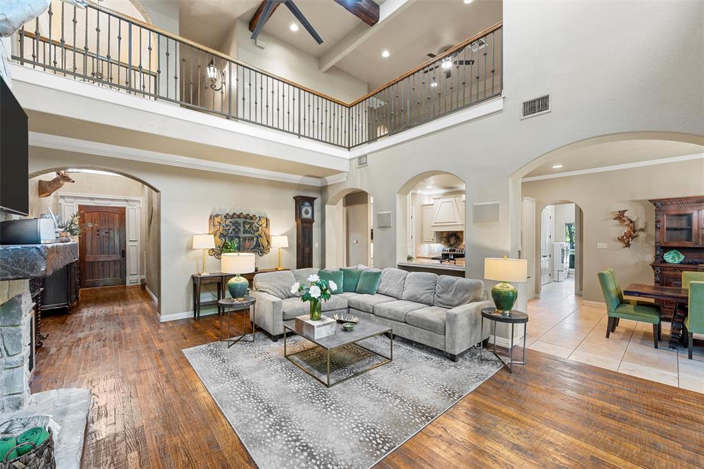 338 Estes Rch Road Bruceville, TX 76630 - Photo 12 of 40 a living room with couches and a dining table with wooden floor