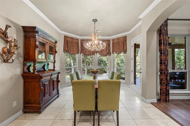 a living room with furniture a chandelier and a large window